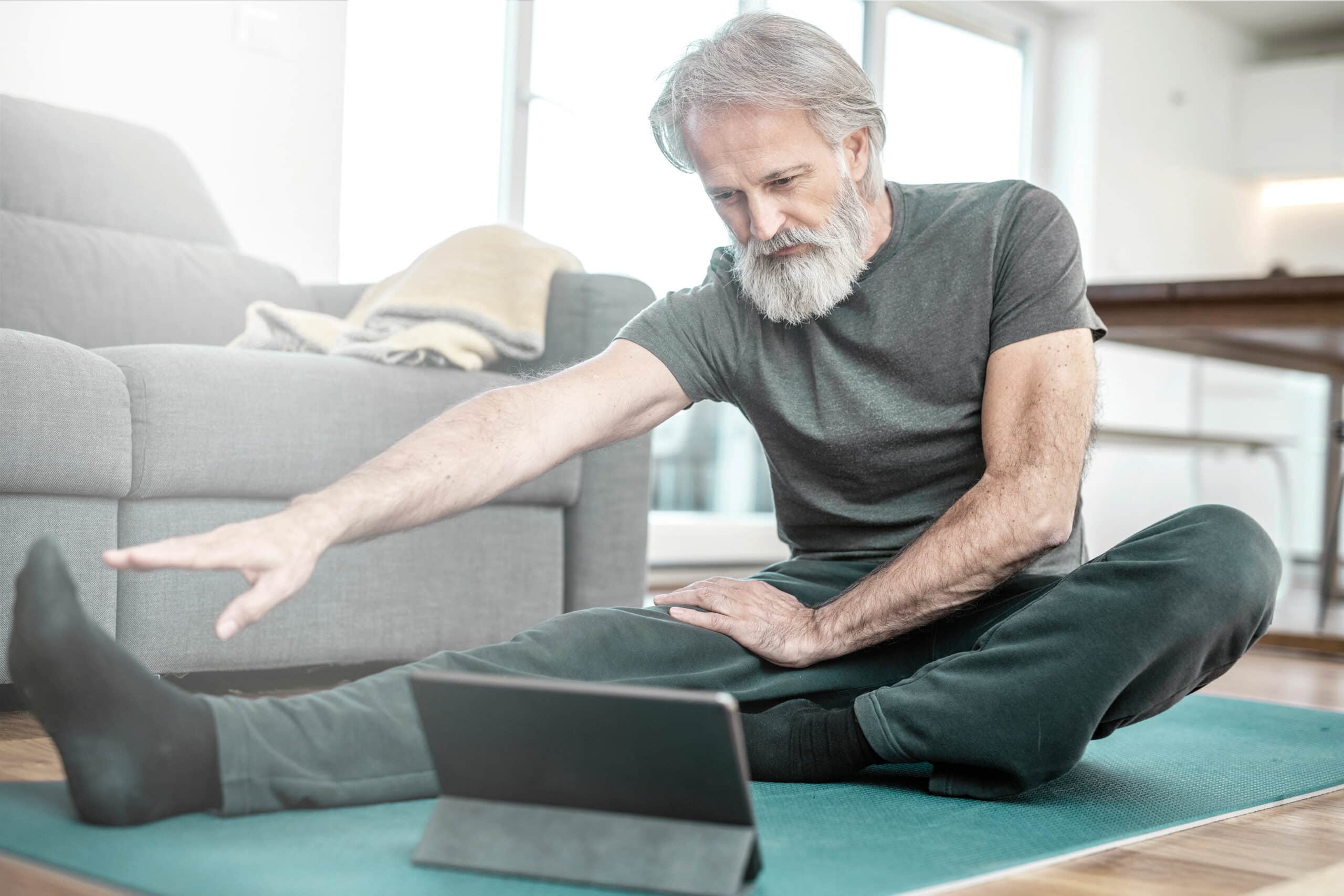 alter Mann macht Dehnübungen